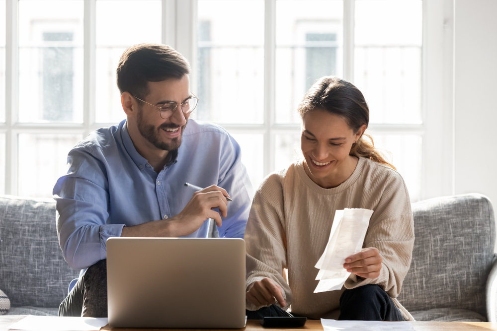 Head,shot,happy,young,family,couple,planning,monthly,budget,,sitting